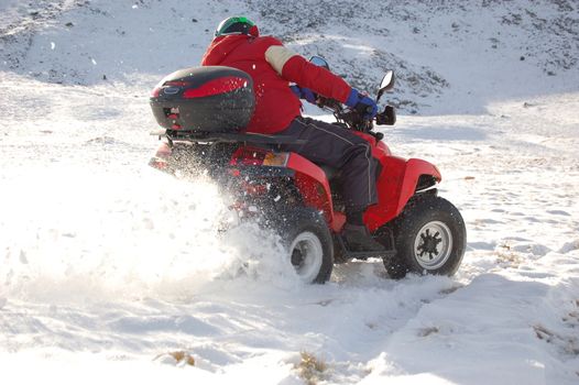 Quad in mountain snow