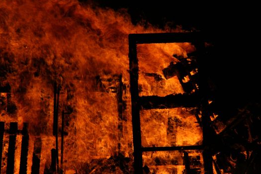 a house burning in flames, accidental fire