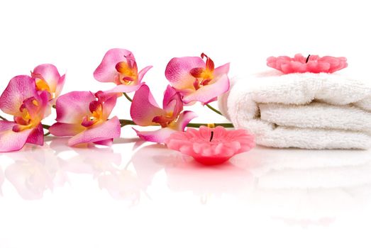 A beautiful orchid, towel and candles