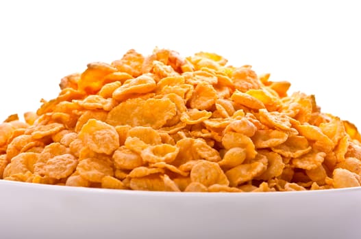 Goldish corn flakes. Macro with extremely shallow dof. Close-up of cornflakes.