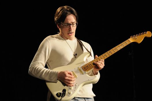 Lead guitarist in the band "Amalgamation" playing guitar in a live concert