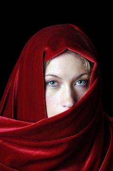 Beautiful young blond with a red velvet shawl over head