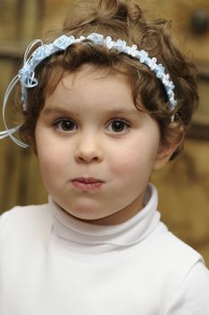 smiling young flower girl at a wedding after she got a mouthful of cake