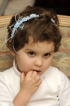 smiling young flower girl at a wedding eating at the reception