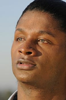 closeup of a young African American man with bloodshot eyes from allergies