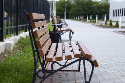 High resolution image. Bench in city street. City sidewalk.