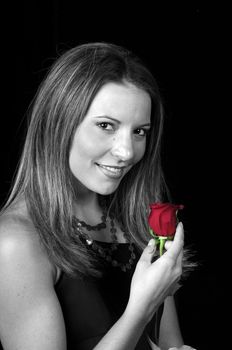 Black and white of Beautiful young woman with a red rose