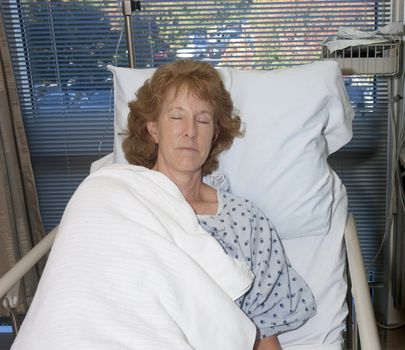 woman asleep in hospital bed