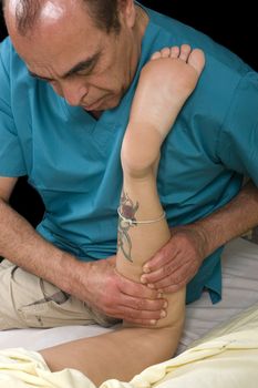 Woman having leg Massage from masseur