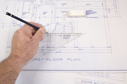 Architect changing drawing of plans for a house