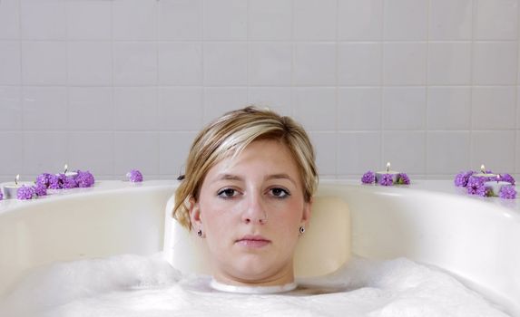 Woman having mud body treatment in a spa