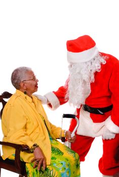 Santa talking to an African American female senior citizen isolated on a white background