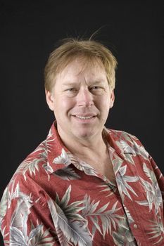 middle aged man in floral shirt man isolated on black