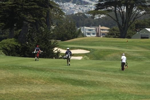3 Golfers walking the course