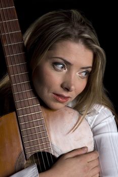 female guitarist caressing guitar in close up isolated on black 