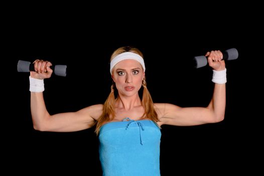 Young blond sportswoman over a black background