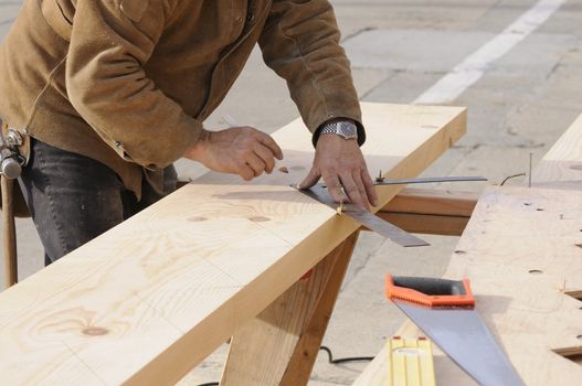 Carpentermarking out the steps on a stringer for a staircase