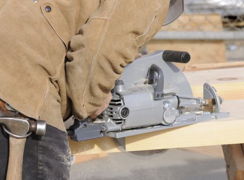 Carpenter cutting steps into a 4x12 stringer for a commercial building