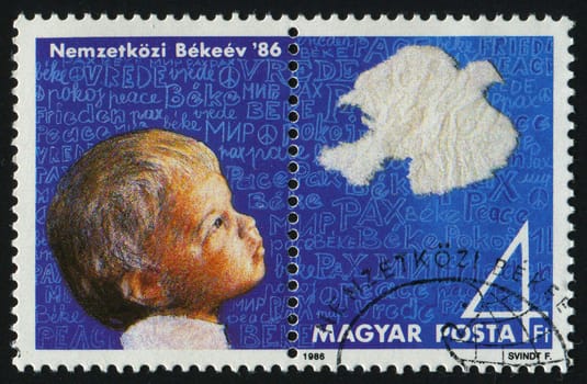 HUNGARY - CIRCA 1986: Peace Year. The boy with a pigeon, circa 1986.