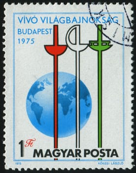 HUNGARY - CIRCA 1975: Epee, Saber Foil and Globe, circa 1975.
