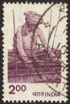 The scanned stamp. The Indian stamp. The old man weaves a carpet.