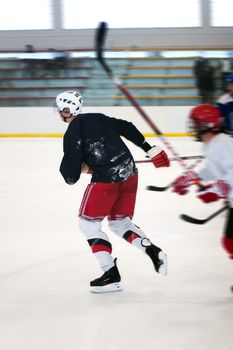 Abstract motion blur of two hockey players skating down the ice rink.