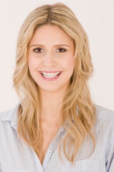 Portrait of a blonde girl with nice teeth smiling