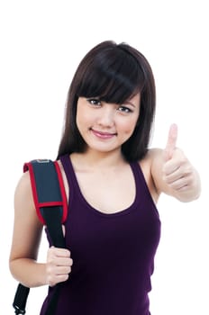 Portrait of a cute young female student giving thumb up sign over white background.