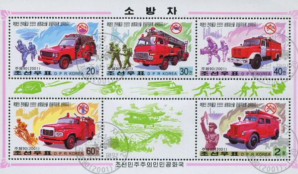 NORTH KOREA - CIRCA 2001: Fire-fighting vehicles and logos warning against specific fire hazards, circa 2001.