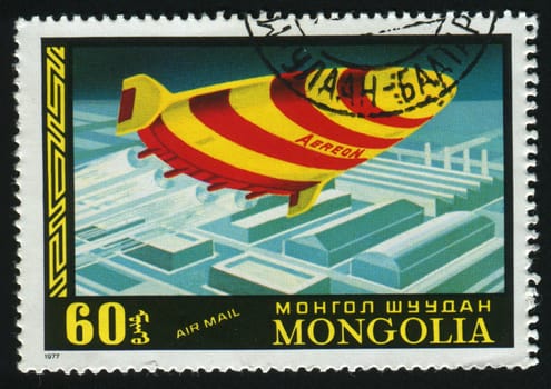 MONGOLIAN - CIRCA 1977: The future spaceship flies over a city, circa 1977.