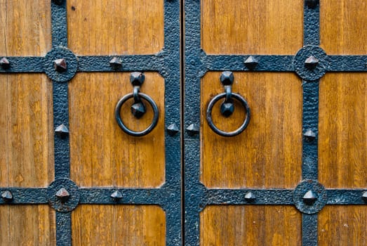 Wooden vintage door with metal door handle, old medival style taken in Moscow, Russia
