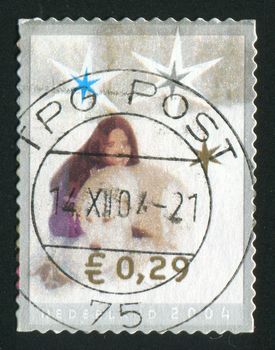 NETHERLANDS - CIRCA 2004: Christmas stamp. Girl and dog, circa 2004.