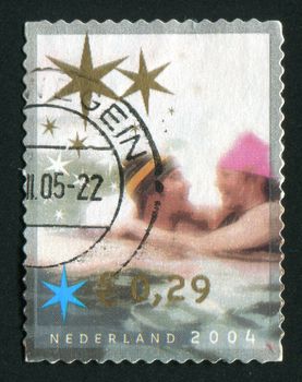 NETHERLANDS - CIRCA 2004: Christmas stamp. Man and woman in water, circa 2004.