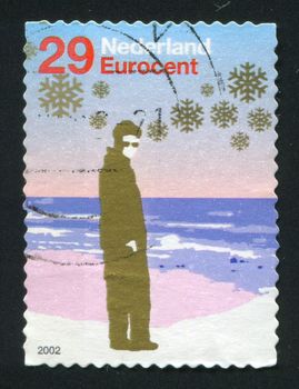NETHERLANDS - CIRCA 2004: Person with sunglasses standing near shore, circa 2004.