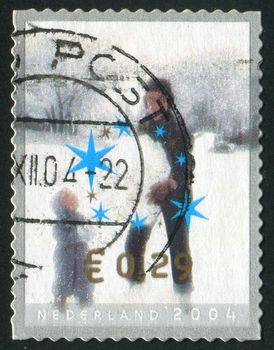 NETHERLANDS - CIRCA 2004: Children making snowman, circa 2004.