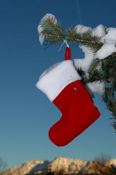 Santa Claus Christmas boot for gifts outside in a snowy landscape