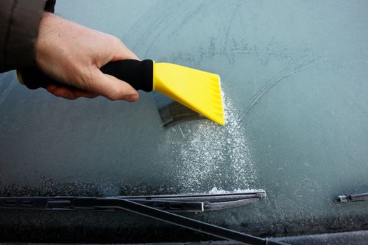 car windshield covered with ice and snow