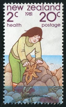 NEW ZEALAND - CIRCA 1981: The girl catches a starfish, circa 1981.