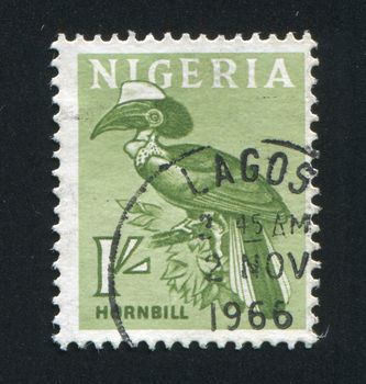 NIGERIA - CIRCA 1966:  The bird sits on a tree branch, circa 1966.