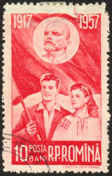 The scanned stamp. Stamp of Romania. The guy and the girl against a flag.