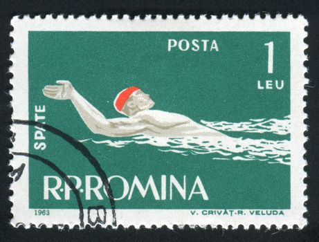 ROMANIA -CIRCA 1963: Sports competitions on a backstroke, circa 1963.
