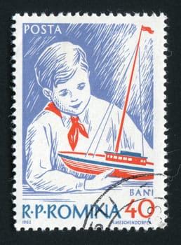 ROMANIA - CIRCA 1962: The Romanian pioneer plays with a ship, circa 1962.