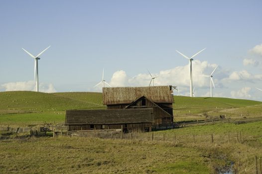 Wind powered generators and dilapidated barn in Northern California