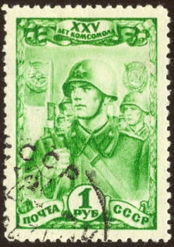The scanned stamp. The Soviet stamp. Soldiers march. Soldiers with rifles and bayonets.