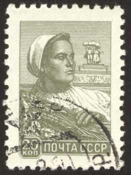 The scanned stamp. The Soviet stamp. The woman reaps wheat crop.