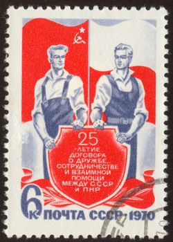 The scanned stamp. Soviet stamp. Two workers against flags.