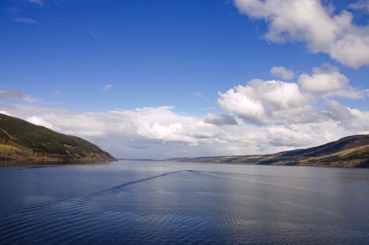 Loch Ness, with tourist boat cruising the loch creating a wake