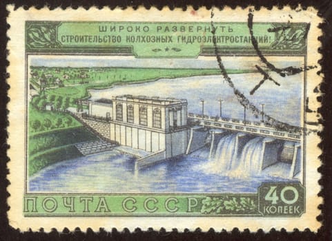 The scanned stamp. The Soviet stamp. Hydroelectric power station in a village place.