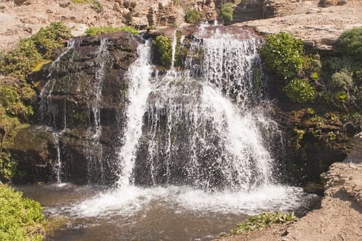 small waterfall leading to the beach