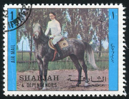 SHARJAH & DEPENDENCIES  - CIRCA 1970: The person sits on a horse, circa 1970.
